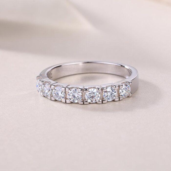 A refined seven-stone band set with shimmering 0.1-carat moissanites, each held in a sculpted claw setting that catches the light with every move. Sleek, polished, and effortlessly elegant — a modern classic crafted for everyday luxury A refined seven-stone band set with shimmering 0.1-carat moissanites, each held in a sculpted claw setting that catches the light with every move. Sleek, polished, and effortlessly elegant — a modern classic crafted for everyday luxury