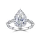 A 3-carat pear-cut moissanite that glows like liquid fire, wrapped in a halo of icy brilliance and a seductive pavé band