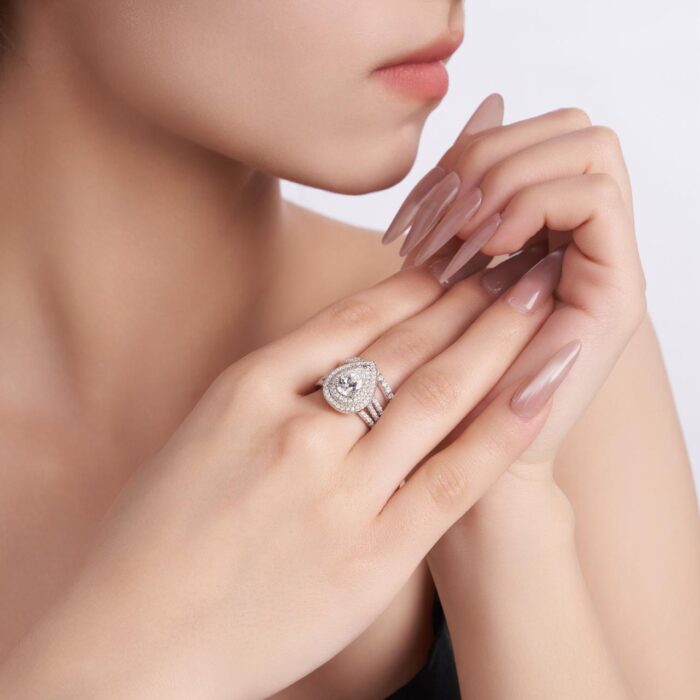 A 1.5-carat moissanite embraced by tiered halos and sculpted pavé rows ,a bold, couture statement that flashes with intense, irresistible brilliance