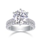 A bold 5-carat moissanite centerpiece ignites with icy fire, lifted on a sleek pavé band and paired with a perfectly matched diamond-lined alliance. A brilliant, modern duo made for unforgettable eleganc