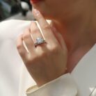 A bold 5-carat moissanite centerpiece ignites with icy fire, lifted on a sleek pavé band and paired with a perfectly matched diamond-lined alliance. A brilliant, modern duo made for unforgettable eleganc