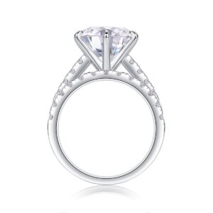 A bold 5-carat moissanite centerpiece ignites with icy fire, lifted on a sleek pavé band and paired with a perfectly matched diamond-lined alliance. A brilliant, modern duo made for unforgettable eleganc
