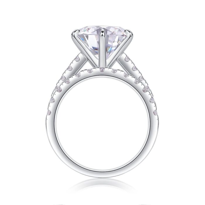 A bold 5-carat moissanite centerpiece ignites with icy fire, lifted on a sleek pavé band and paired with a perfectly matched diamond-lined alliance. A brilliant, modern duo made for unforgettable eleganc