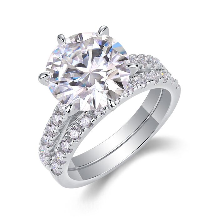 A bold 5-carat moissanite centerpiece ignites with icy fire, lifted on a sleek pavé band and paired with a perfectly matched diamond-lined alliance. A brilliant, modern duo made for unforgettable eleganc