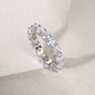 A continuous circle of 0.3-carat moissanites, each meticulously set to create an unbroken ribbon of brilliance. Sculpted with elevated prongs for maximum light play, this eternity band delivers a statement of refined sparkle and timeless elegance